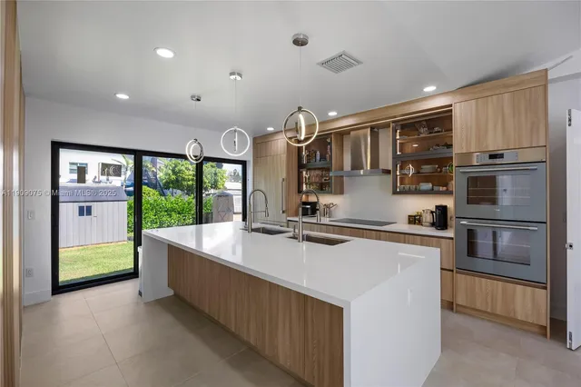 a kitchen with stainless steel appliances granite countertop a stove and a refrigerator