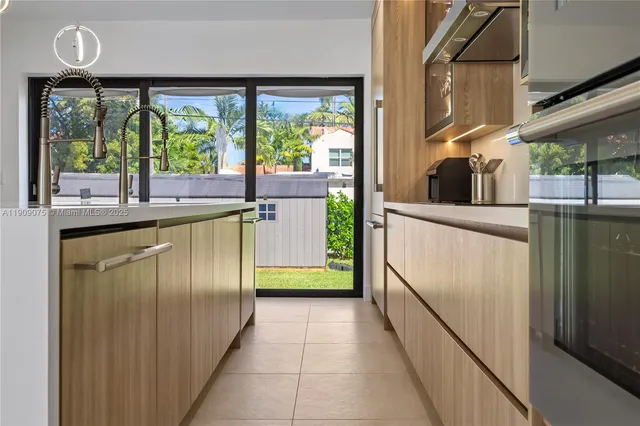 a kitchen with stainless steel appliances granite countertop a refrigerator and a stove