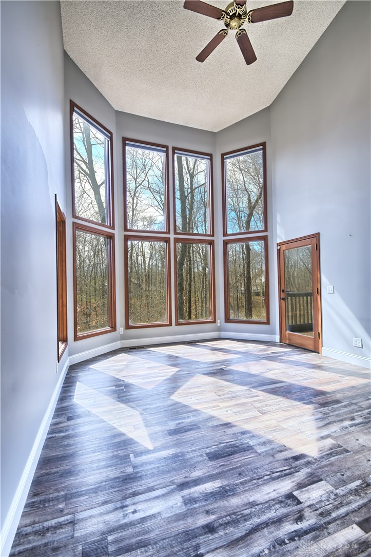 8711 Nicole Lane Springboro, OH 45066 - Photo 21 of 87 This airy room features expansive windows framing serene nature views, perfect for peaceful living.
