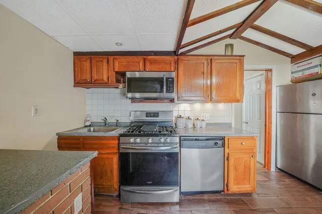 a bedroom with bed chair and wooden floor