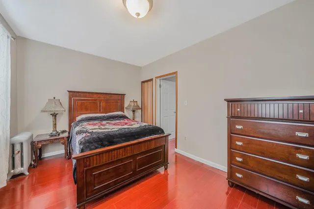 a bedroom with a bed and a ceiling fan