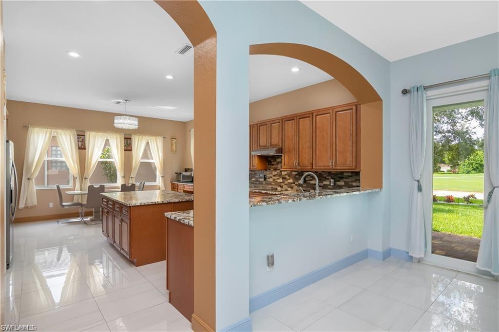 2181 Vardin Place Naples, FL 34120 - Photo 14 of 37 a view of a living room and kitchen