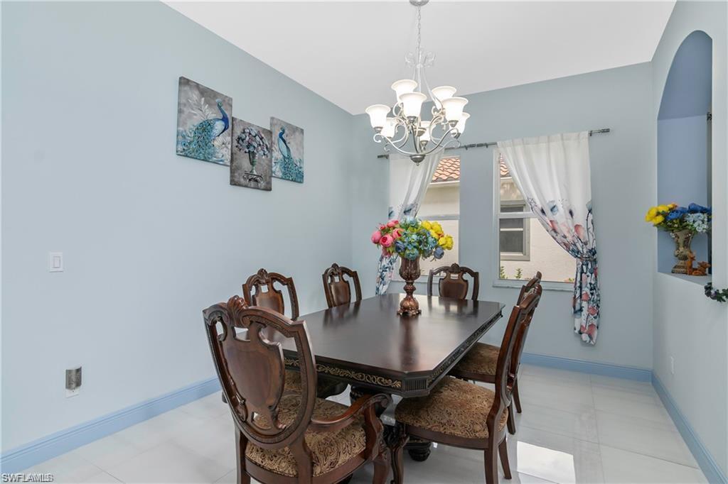 2181 Vardin Place Naples, FL 34120 - Photo 16 of 37 a view of a dining room with furniture and chandelier