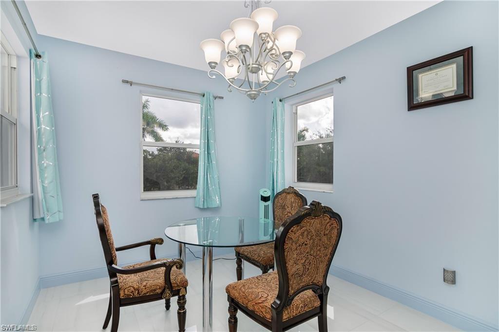 2181 Vardin Place Naples, FL 34120 - Photo 17 of 37 a dining room with furniture and window