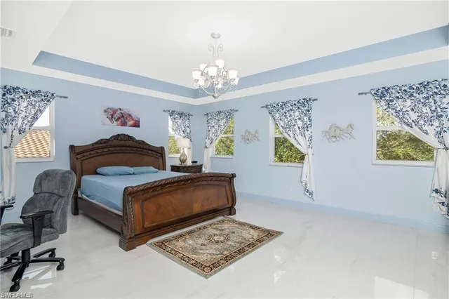 a bedroom with a bed dresser and window