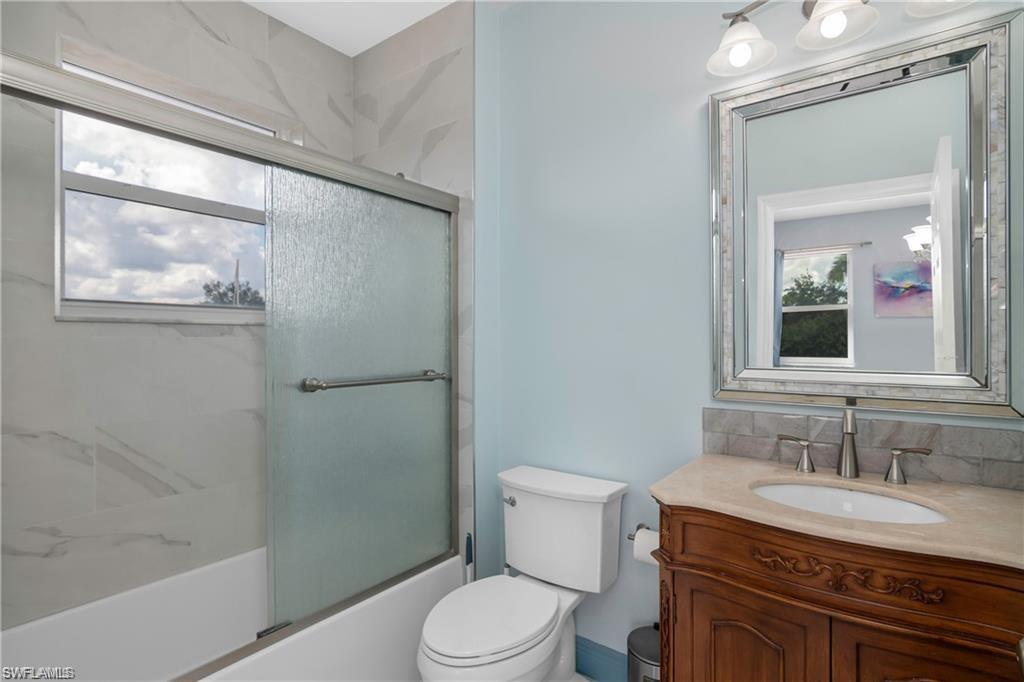 2181 Vardin Place Naples, FL 34120 - Photo 27 of 37 a bathroom with a granite countertop sink toilet and shower