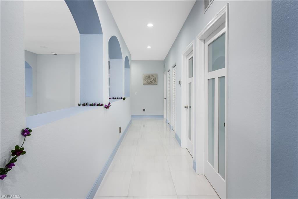 2181 Vardin Place Naples, FL 34120 - Photo 8 of 37 a view of a hallway with white walls