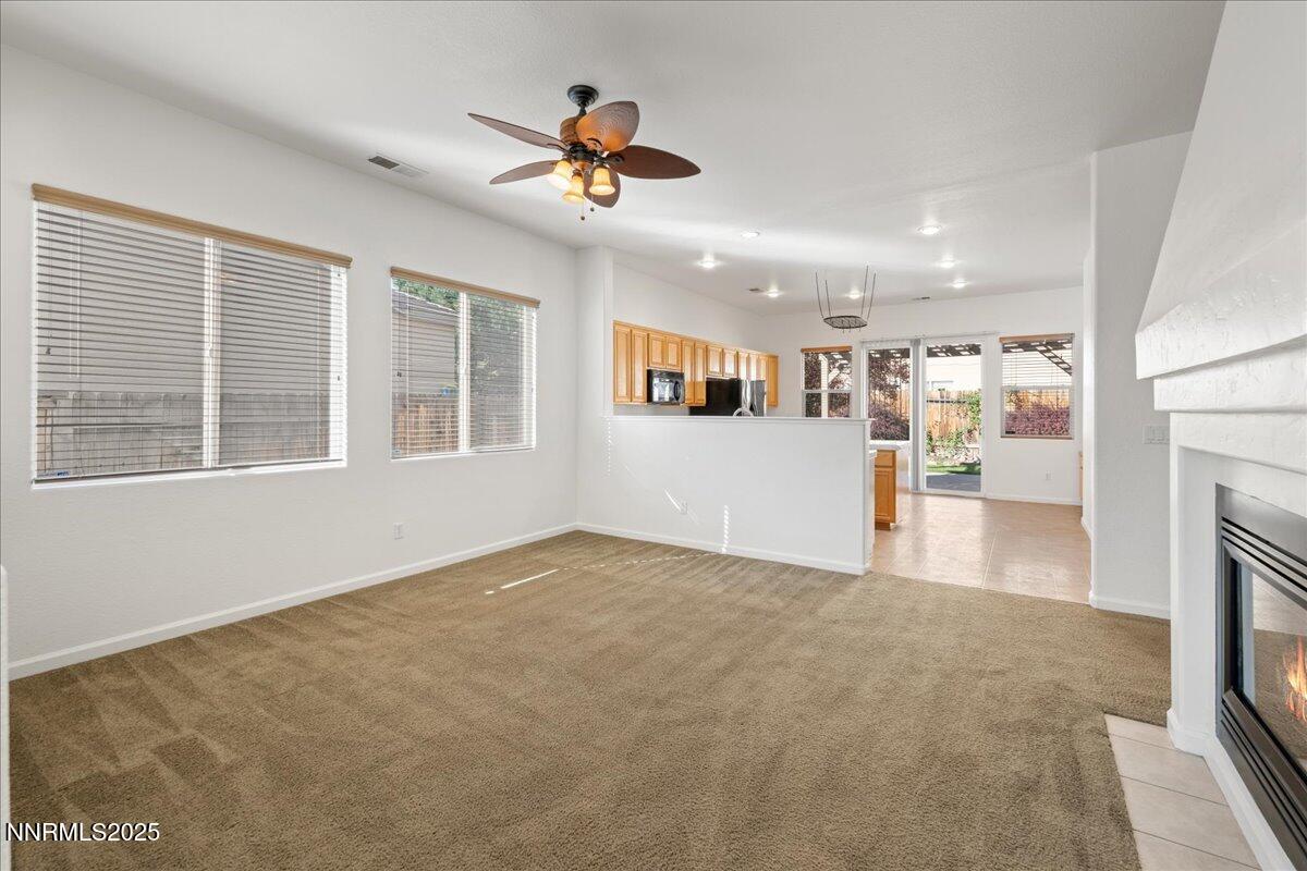 10583 Crystal Bay Drive Reno, NV 89521 - Photo 11 of 43 a view of an empty room with a window and kitchen view