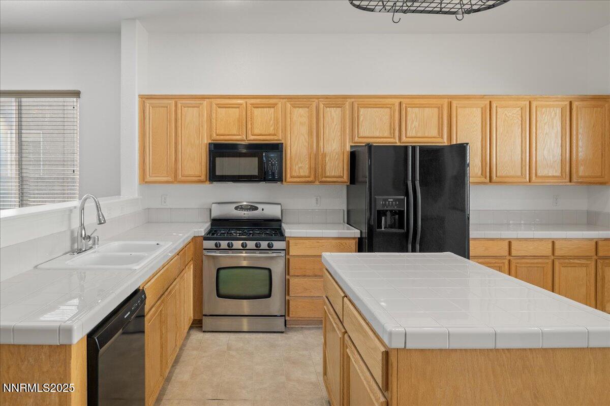 10583 Crystal Bay Drive Reno, NV 89521 - Photo 14 of 43 a kitchen with a stove a refrigerator and a sink