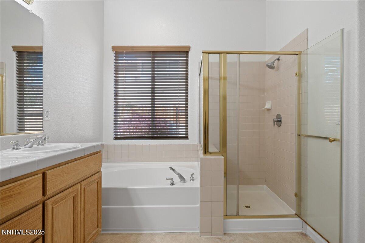 10583 Crystal Bay Drive Reno, NV 89521 - Photo 24 of 43 a bathroom with a granite countertop sink and a bathtub