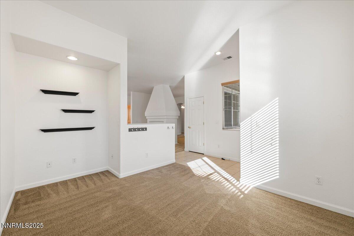 10583 Crystal Bay Drive Reno, NV 89521 - Photo 8 of 43 an empty room with a mirror and stairs