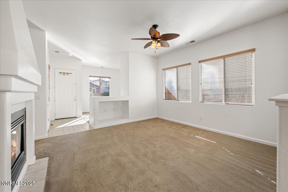 10583 Crystal Bay Drive Reno, NV 89521 - Photo 9 of 43 a view of an empty room with a fireplace and a window