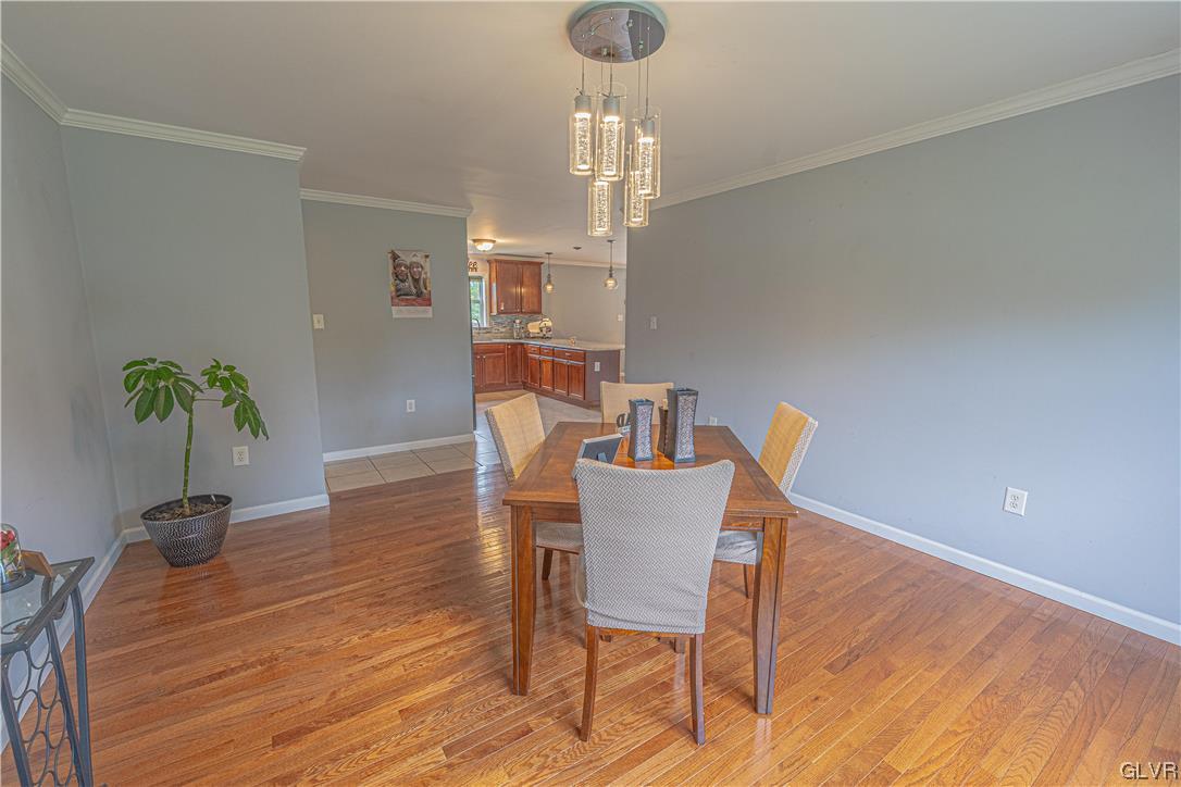897 North Summit Road Bath, PA 18014 - Photo 11 of 35 a dining room with furniture potted plants and wooden floor