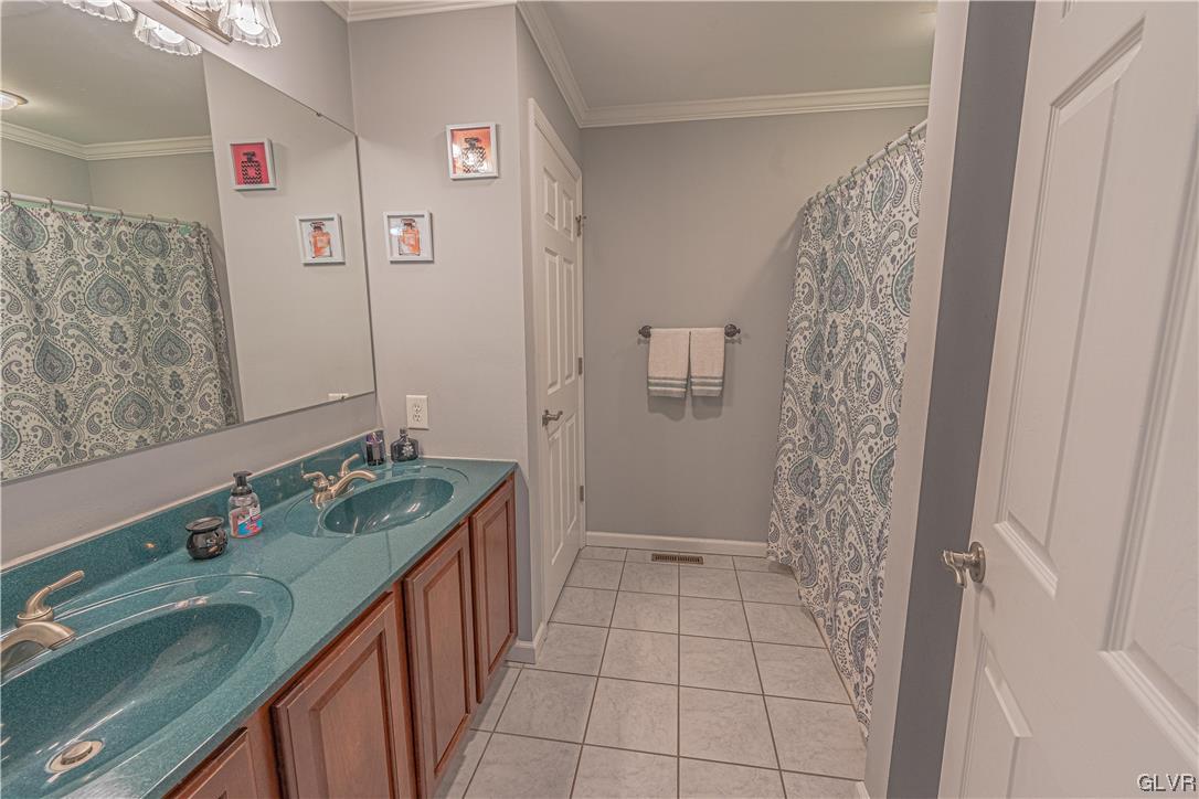 897 North Summit Road Bath, PA 18014 - Photo 15 of 35 a bathroom with a double vanity sink and mirror