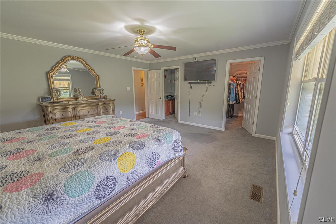 897 North Summit Road Bath, PA 18014 - Photo 16 of 35 a bedroom with a bed and a chandelier