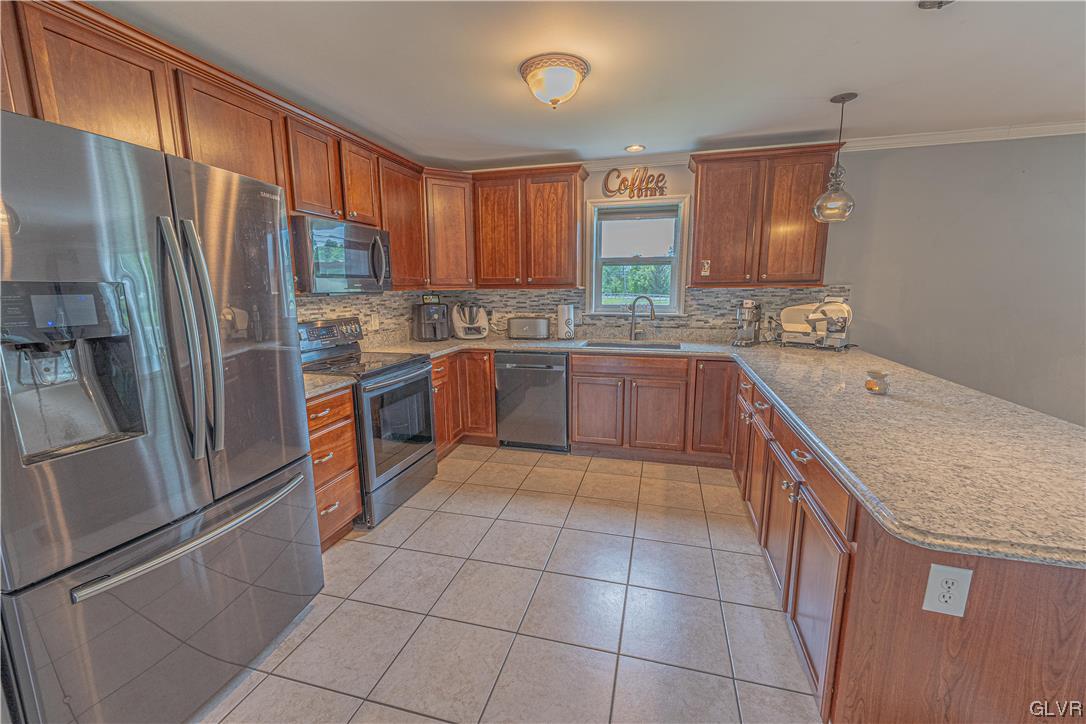 897 North Summit Road Bath, PA 18014 - Photo 10 of 35 a kitchen with stainless steel appliances granite countertop a sink stove refrigerator and cabinets