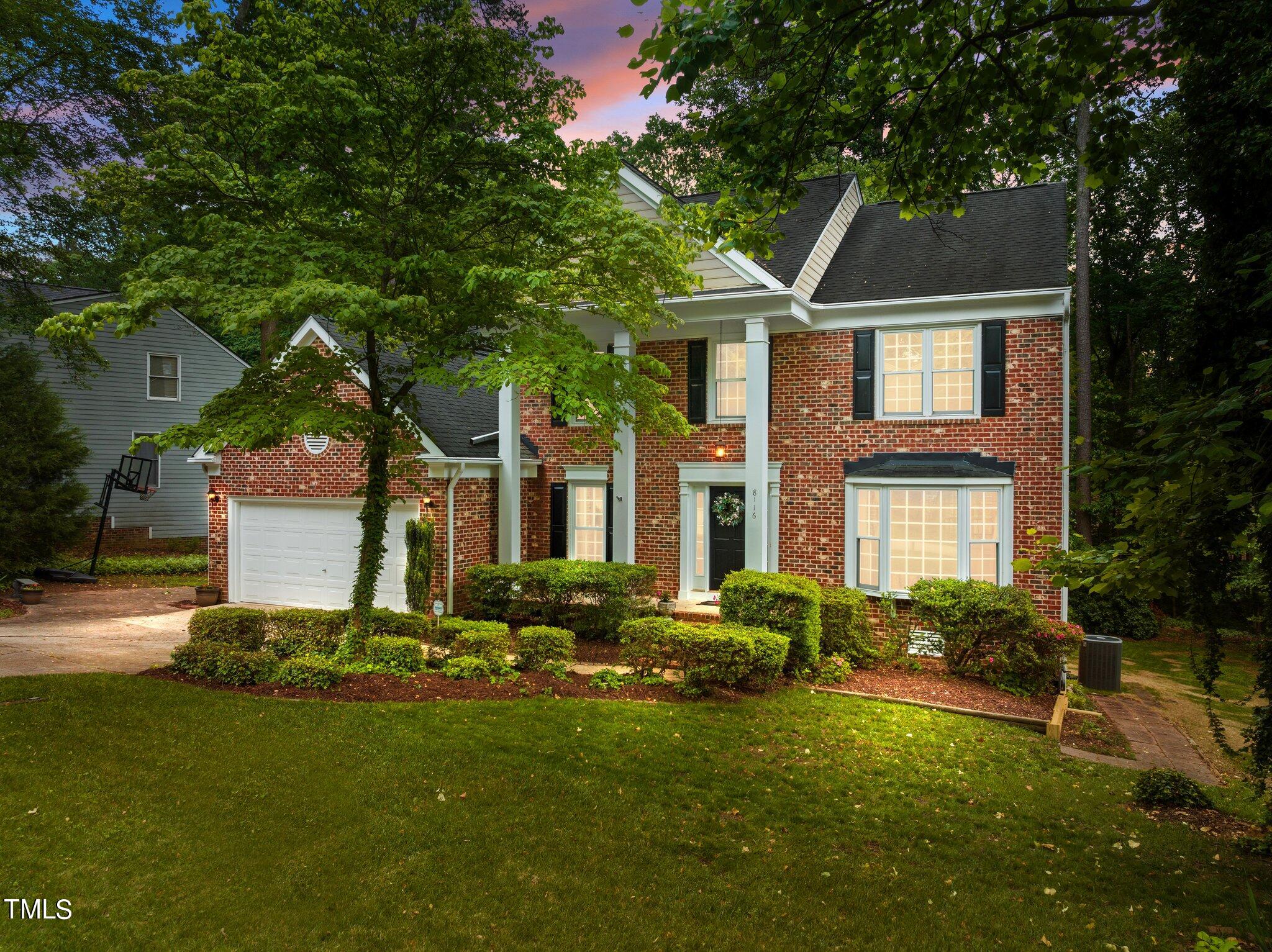 8116 Coleraine Court Raleigh, NC 27615 - Photo 55 of 58 a front view of a house with a yard