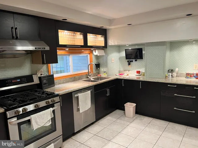 a kitchen with a sink stove and microwave