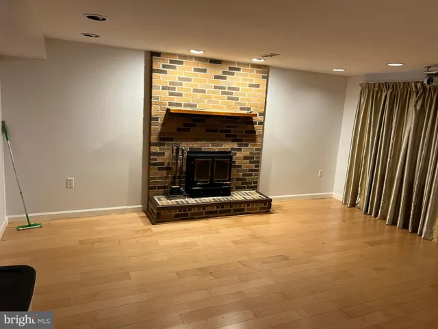 a view of an empty room with a fireplace