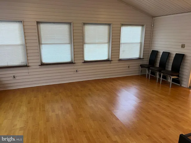 a view of a room with furniture and wooden floor