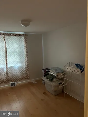 a room with water heater and a wooden door