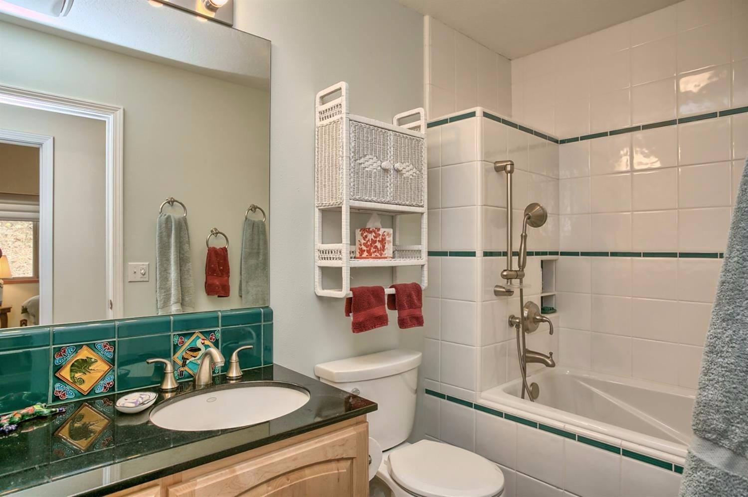 8009 Dead Indian Memorial Road Ashland, OR 97520 - Photo 20 of 24 a bathroom with a granite countertop sink mirror vanity and toilet