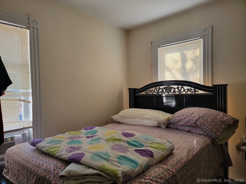 40 5th Street Bridgeport, CT 06607 - Photo 3 of 8 a bedroom with a bed next to a window