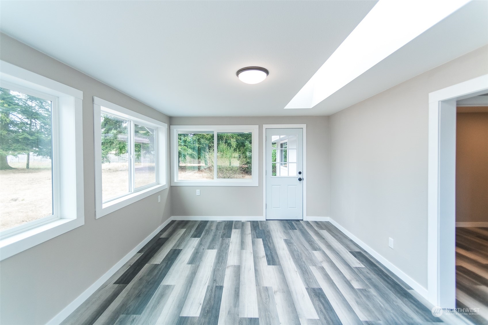 4820 176th Avenue Southwest Rochester, WA 98579 - Photo 14 of 40 a view of a room with wooden floor and windows