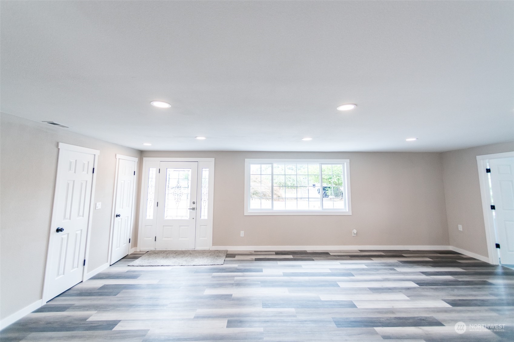 4820 176th Avenue Southwest Rochester, WA 98579 - Photo 15 of 40 an empty room with wooden floor and window