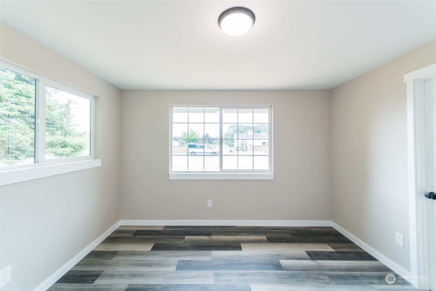 4820 176th Avenue Southwest Rochester, WA 98579 - Photo 26 of 40 an empty room with wooden floor and windows