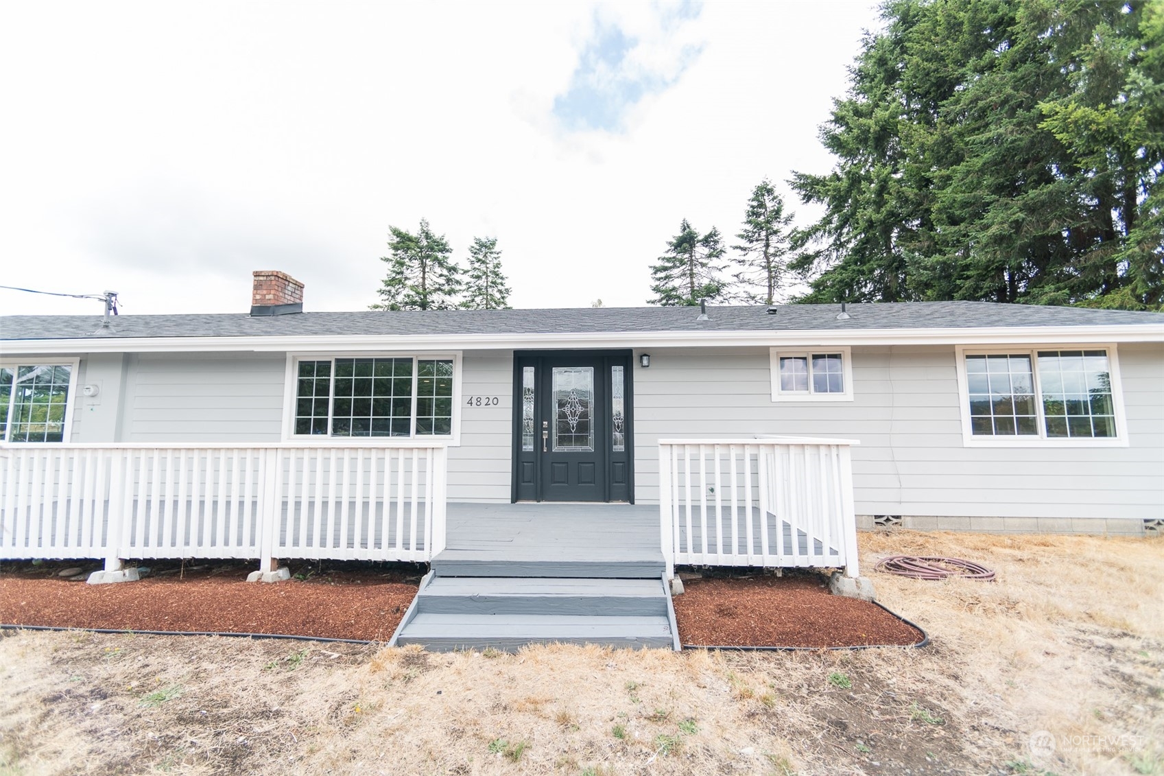 4820 176th Avenue Southwest Rochester, WA 98579 - Photo 3 of 40 a front view of a house with a garden