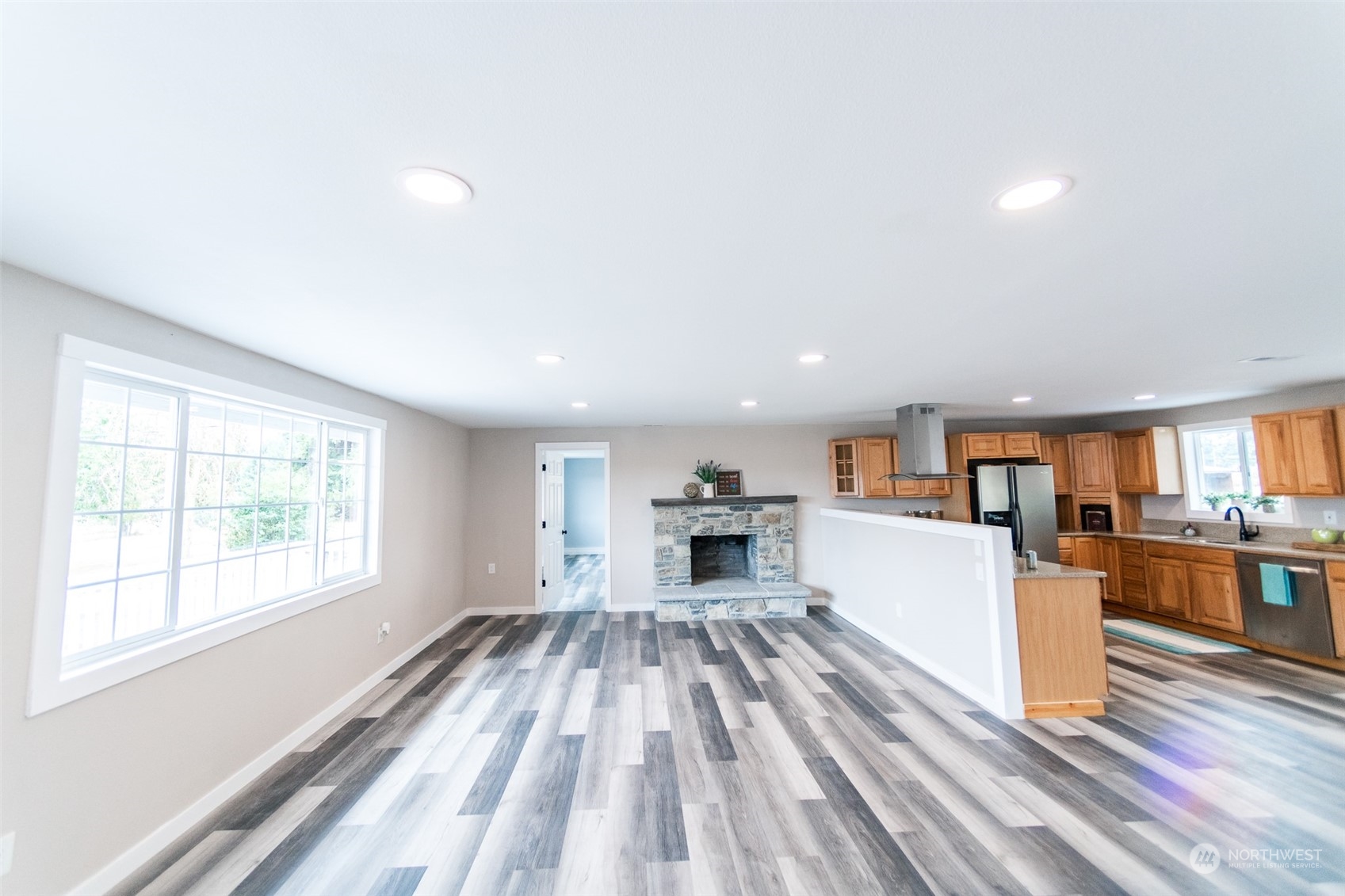 4820 176th Avenue Southwest Rochester, WA 98579 - Photo 4 of 40 a kitchen with a refrigerator a stove top oven a sink dishwasher and wooden cabinets with wooden floor