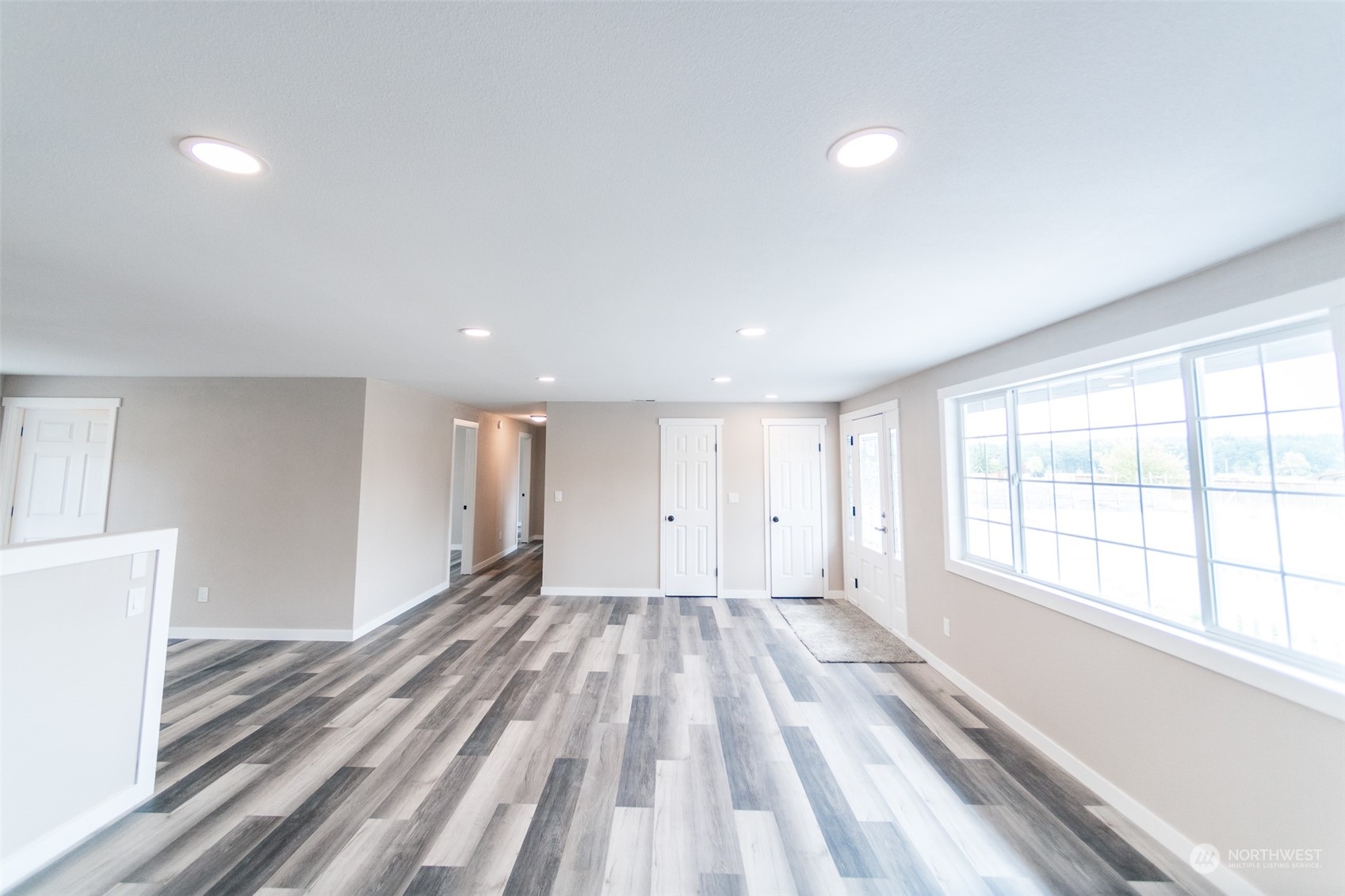 4820 176th Avenue Southwest Rochester, WA 98579 - Photo 5 of 40 a view of wooden floor and windows in a room