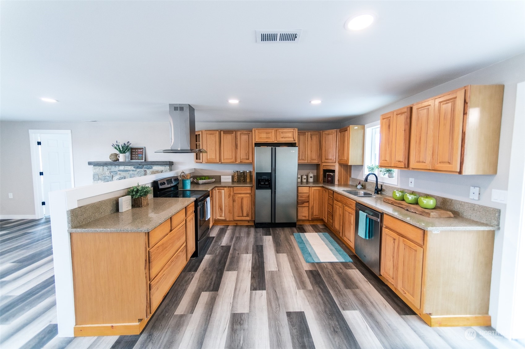 4820 176th Avenue Southwest Rochester, WA 98579 - Photo 6 of 40 a large kitchen with stainless steel appliances granite countertop a large counter top a stove and a refrigerator