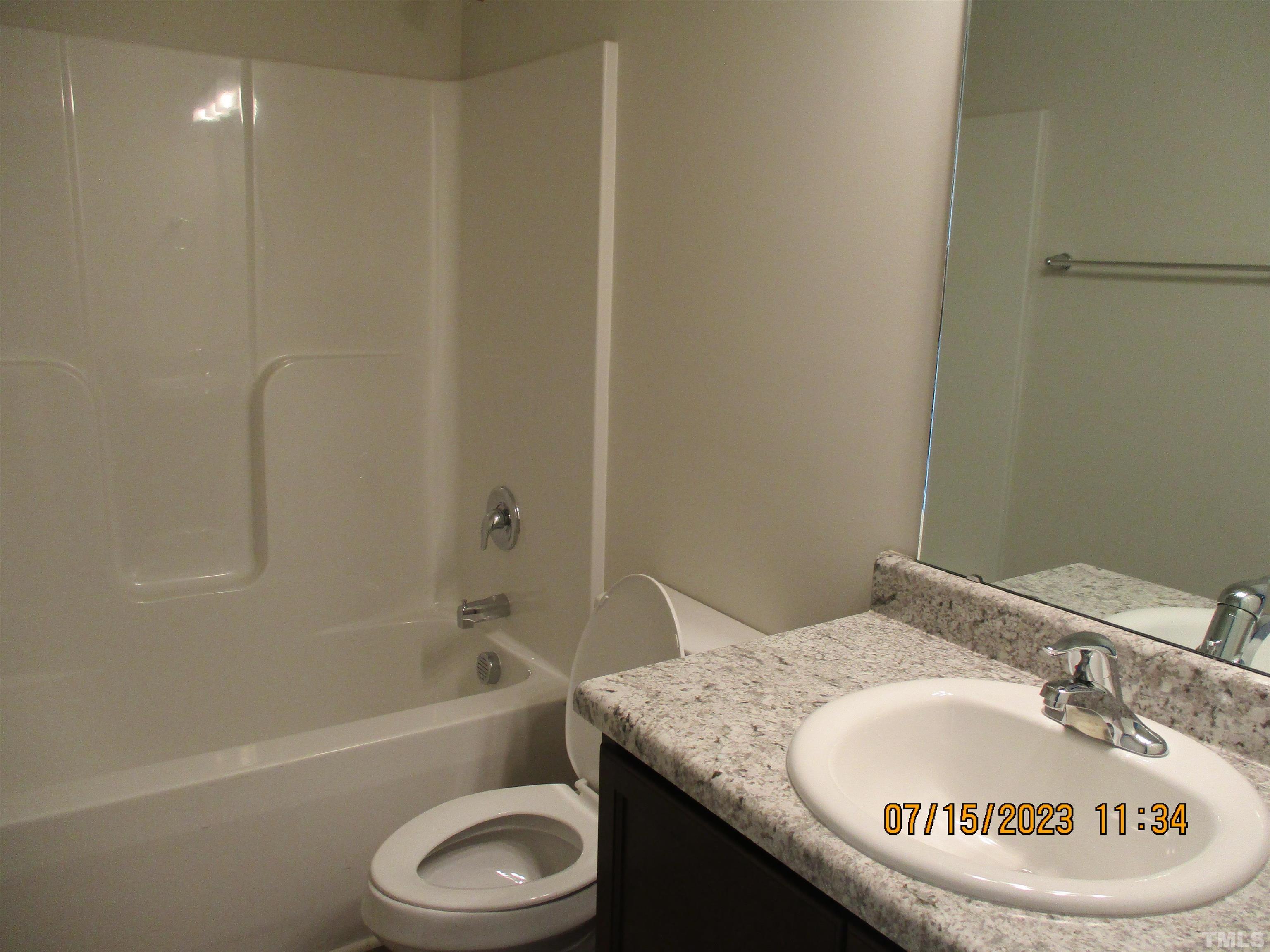 592 Rowan Road Clinton, NC 28328 - Photo 7 of 9 a bathroom with a granite countertop sink a toilet and bathtub