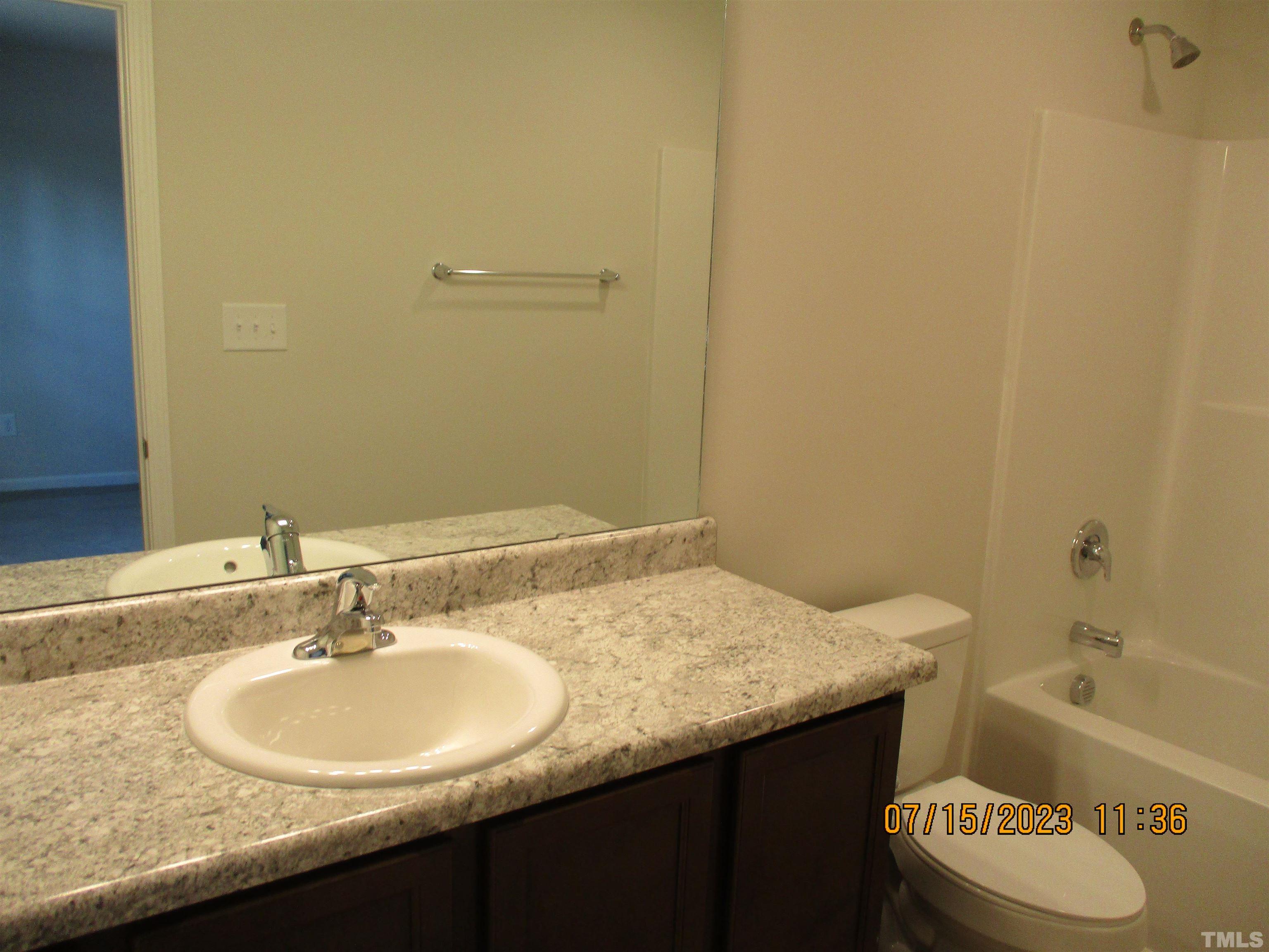 592 Rowan Road Clinton, NC 28328 - Photo 9 of 9 a bathroom with a granite countertop sink and a mirror