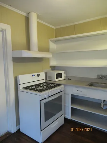 a stove top oven sitting inside of a kitchen