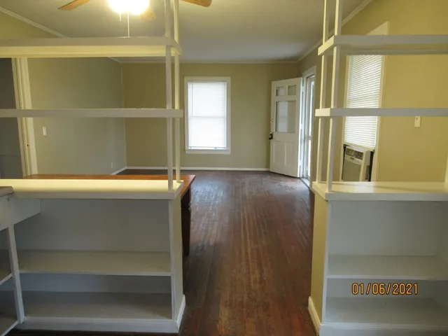 a room with a window and chandelier