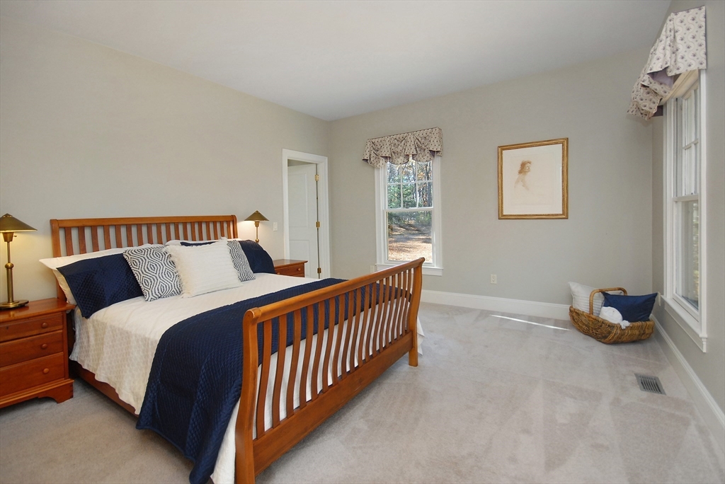96 Forest Ridge Road, Unit 96 Concord, MA 01742 - Photo 18 of 36 a bedroom with bed and window