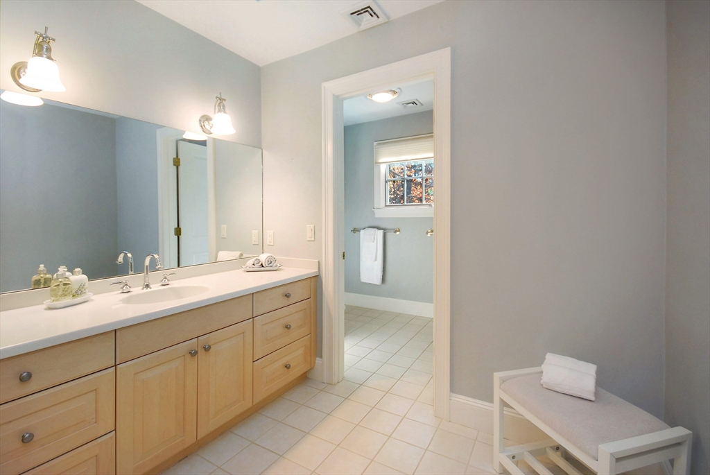 96 Forest Ridge Road, Unit 96 Concord, MA 01742 - Photo 25 of 36 a spacious bathroom with a double vanity sink toilet and mirror