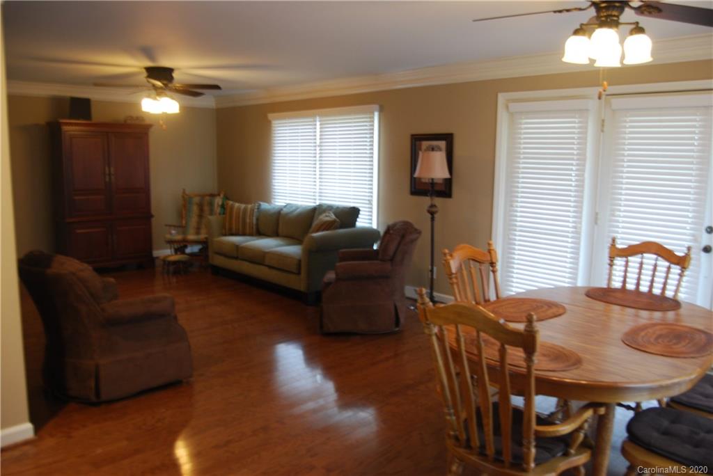 2716 Stack Road Monroe, NC 28112 - Photo 11 of 42 a living room with furniture a chandelier and a dining table