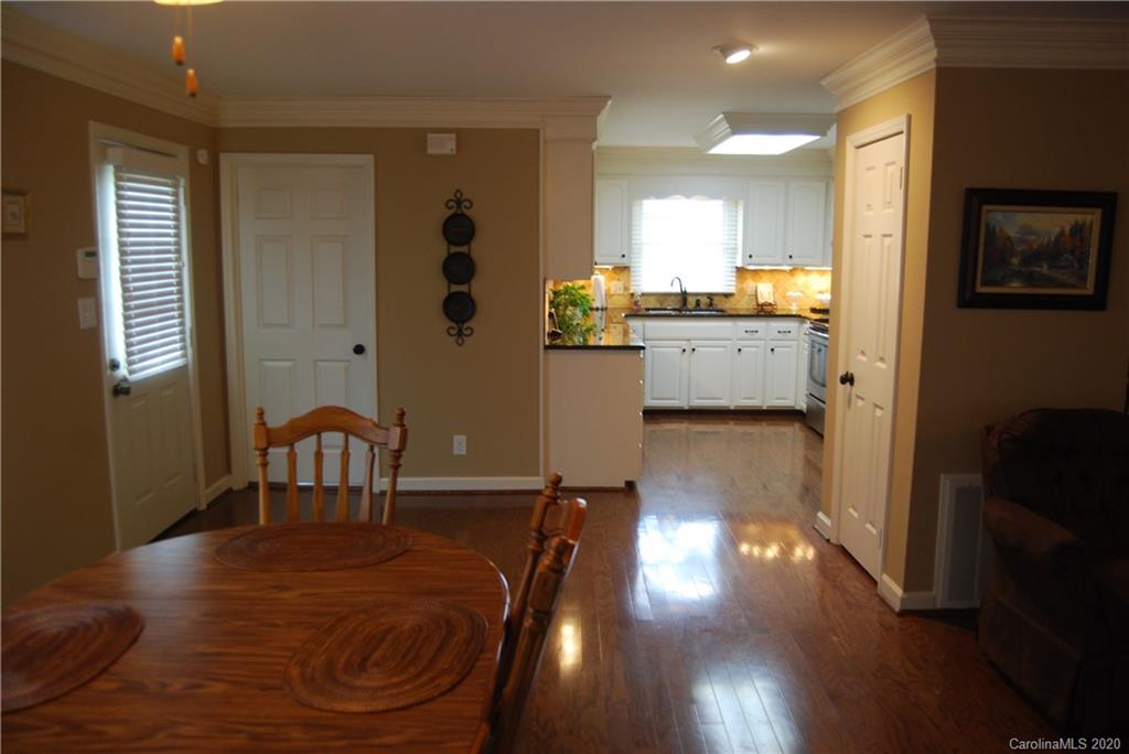 2716 Stack Road Monroe, NC 28112 - Photo 12 of 42 a view of a dining room with furniture and wooden floor