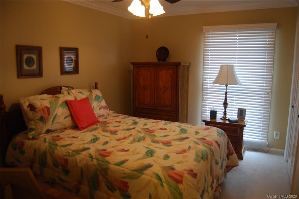 2716 Stack Road Monroe, NC 28112 - Photo 19 of 42 a bedroom with a bed and a chandelier