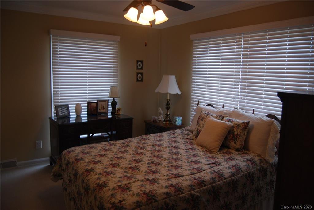 2716 Stack Road Monroe, NC 28112 - Photo 21 of 42 a bedroom with a bed and a lamp on dresser