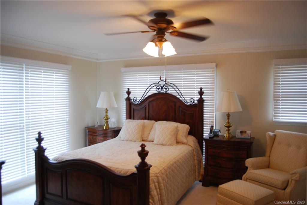 2716 Stack Road Monroe, NC 28112 - Photo 22 of 42 a bedroom with a bed and a chandelier