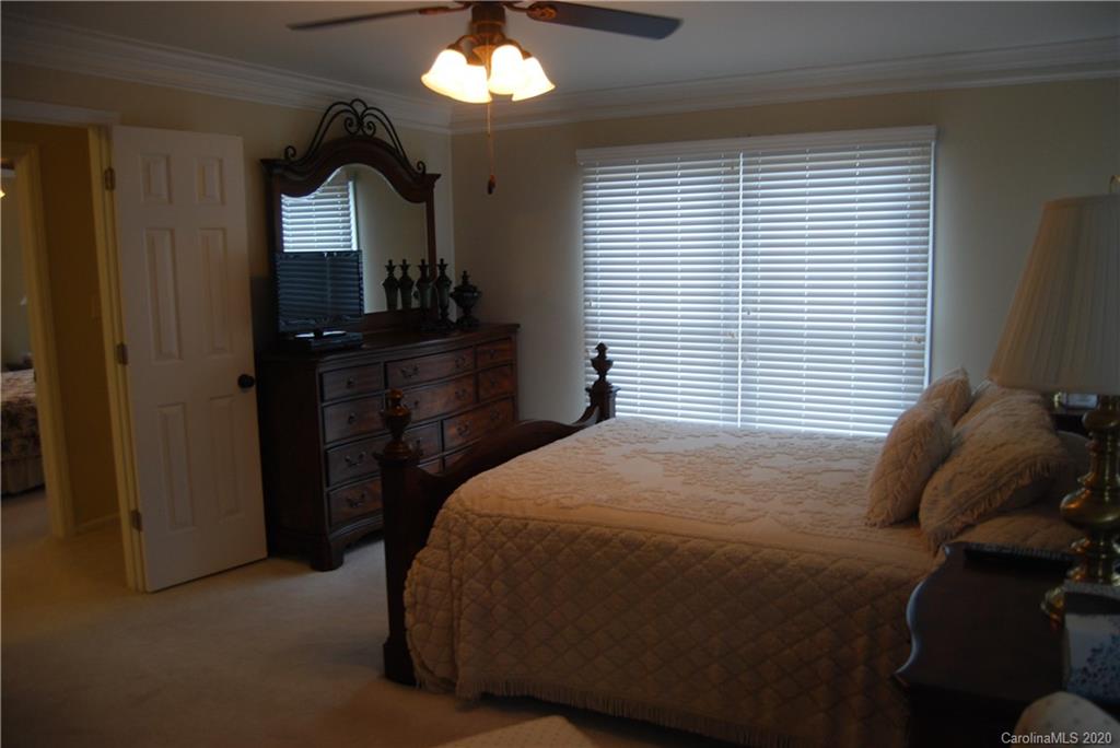 2716 Stack Road Monroe, NC 28112 - Photo 24 of 42 a bedroom with a bed and a chandelier