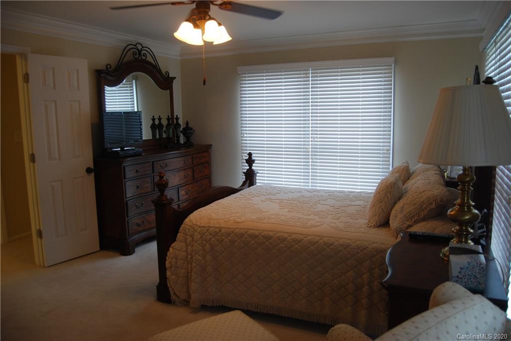 2716 Stack Road Monroe, NC 28112 - Photo 25 of 42 a bedroom with a bed and a bathroom with mirror