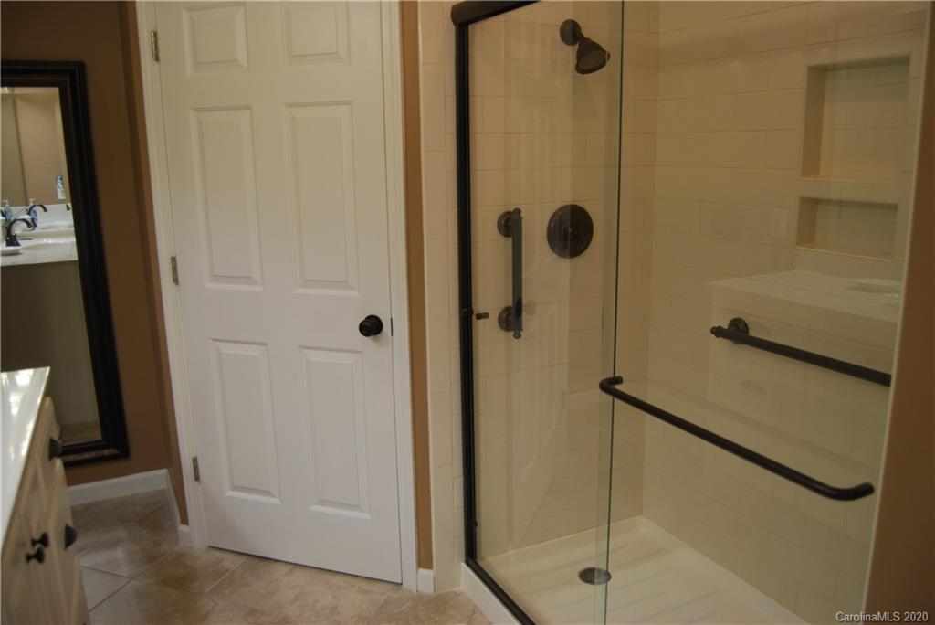 2716 Stack Road Monroe, NC 28112 - Photo 29 of 42 a bathroom with a glass shower door