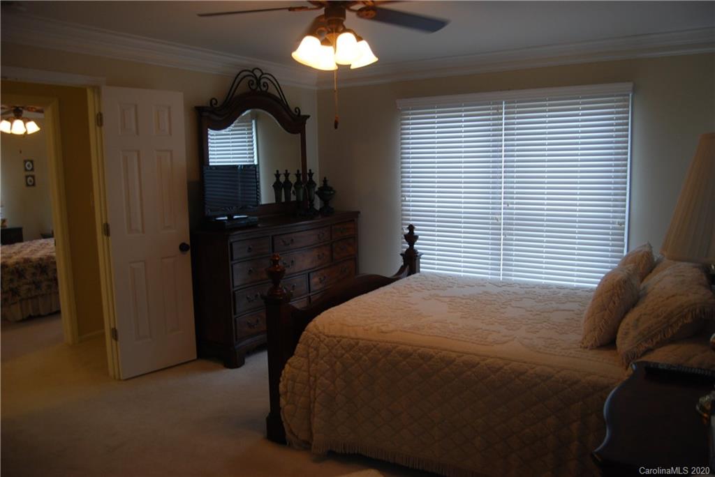 2716 Stack Road Monroe, NC 28112 - Photo 30 of 42 a bedroom with a bed and a mirror on dresser