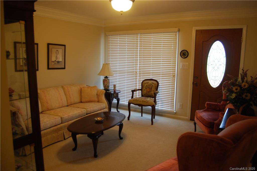 2716 Stack Road Monroe, NC 28112 - Photo 31 of 42 a living room with furniture a mirror and a window